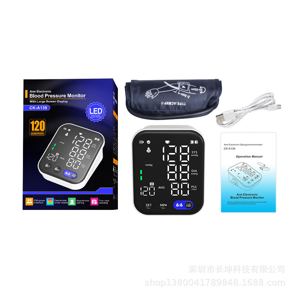 Electronic blood pressure monitor with large LED display, cuff, USB cable, and instruction manual
