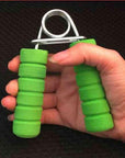 Hand grip strengthener for women with green foam handles held in a hand for fitness exercise